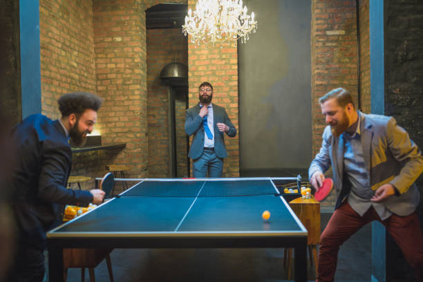 istock Group of young businessman playing table tennis after work 970117410