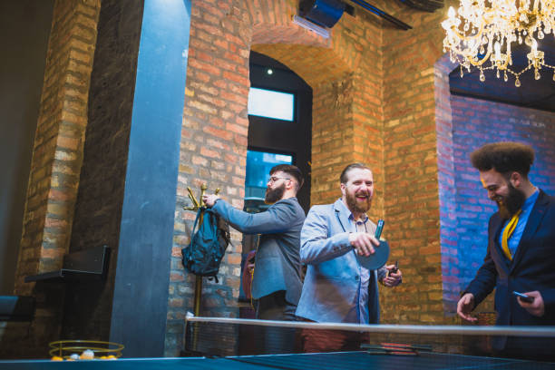 istock Bearded, hipster businessman, taking break after work, playing ping pong 970117468