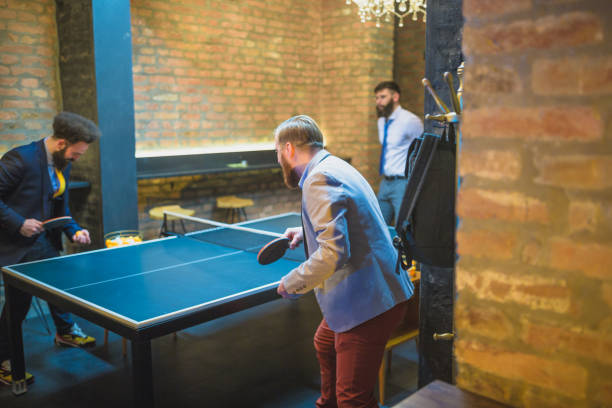istock Group of young businessman playing table tennis after work 970117572
