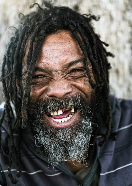 istock Homeless man with dreadlocks laughs joyfully 970121708