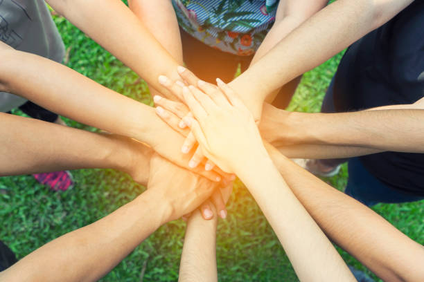 istock Teamwork togetherness collaboration concept, People group join hands together unity symbol during, stacked huddle together, achieve their ultimate goal. 970122686