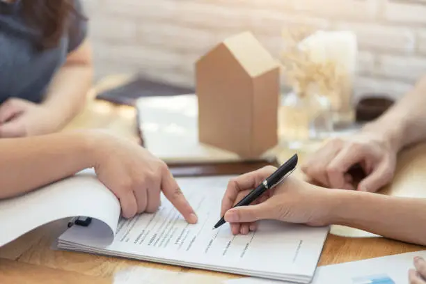 Photo of woman putting signature on document contract, real estate purchase, success business contract deals with sale represent.