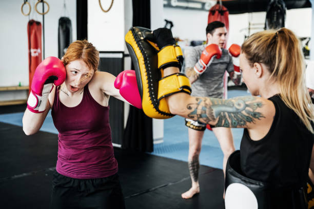 femmes entraîner ensemble au gymnase de kickboxing - muay thai kickboxing women martial arts photos et images de collection