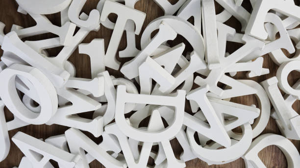 istock random white wooden alphabet letters top view on purple background 970128670