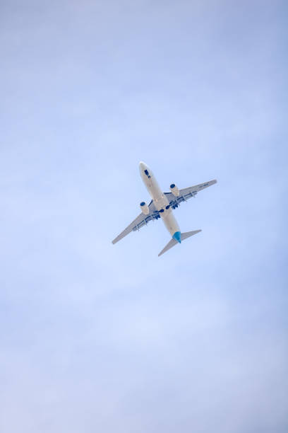 istock Worm's Eye View of a Plane Flying in the Sky 970137122