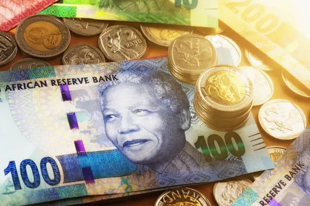 Photo of South African coins and banknotes featuring Nelson Mandela