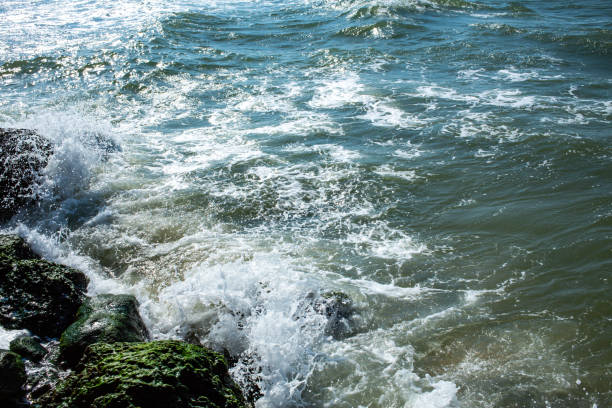 Waves breaking, Waves splashing on stony beach, Thailand
