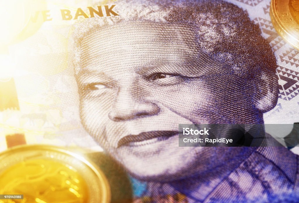 Nelson Mandela features on South African Hundred rand note Face of Nelson Mandela on a large-denomination South African banknote wth Five Rand coin alongside. Nelson Mandela Stock Photo
