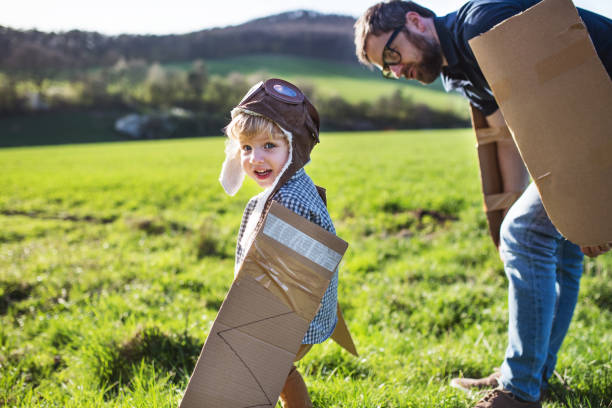 istock Happy toddler boy playing outside with father in spring nature. 970148784