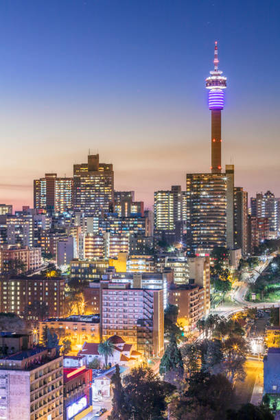 Johannesburg city panorama with the communications tower Johannesburg cityscape sunset with the residential hillbrow suburb and the iconic Telkom communication tower. Johannesburg is one of the forty largest metropolitan cities in the world, and the world's largest city that is not situated on a river, lakeside, or coastline. It is also the source of a large-scale gold and diamond trade, due being situated in the mineral-rich Gauteng province. gauteng province photos stock pictures, royalty-free photos & images
