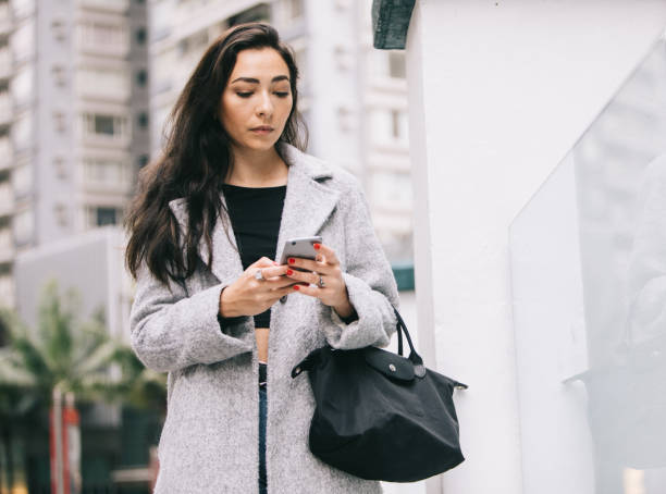istock Woman looking at her phone 970161564