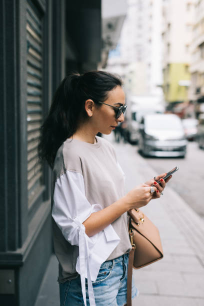 istock Woman using her smartphone on the streets 970161646