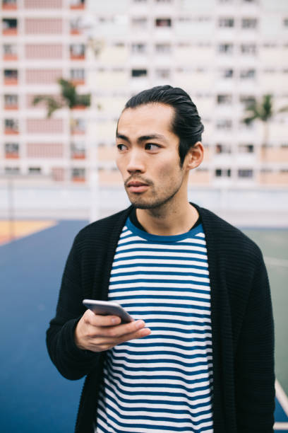istock Young man looking away from his phone. 970162120