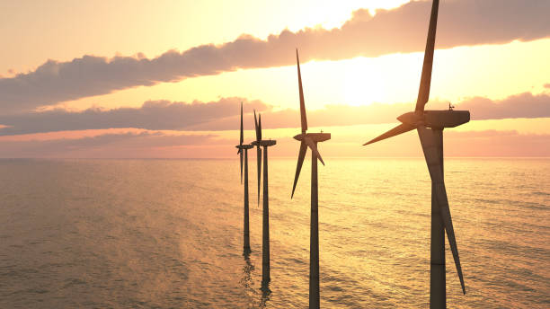 Offshore wind power at sunset stock photo