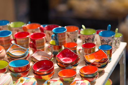colorful pottery dishes on market stall - Spanish pottery