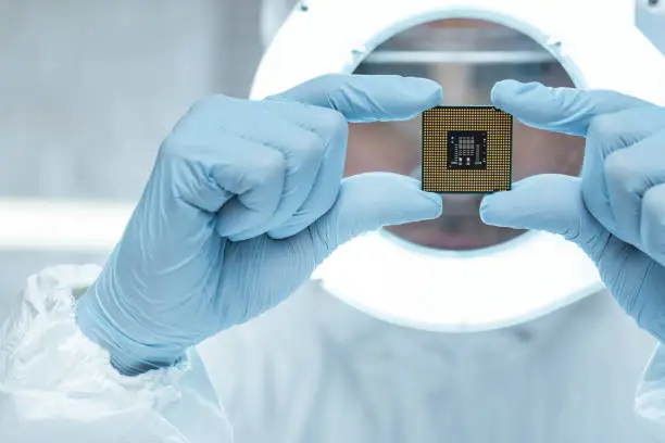 Engineer analyzing computer chip in laboratory