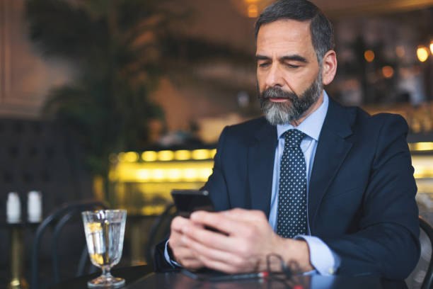 istock Senior businessman working and having a coffee in coffee bar 970183648