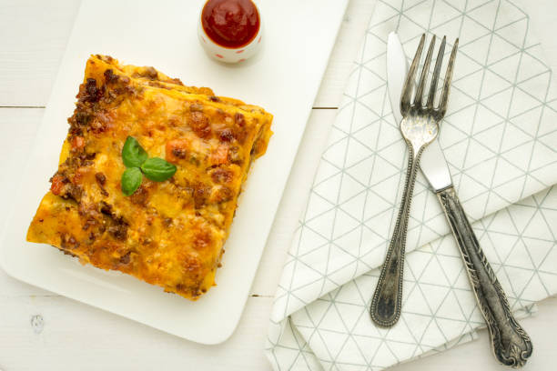 istock Italian Lasagna with Minced Beef, Bolognese Sauce and Basil on White Plate 970189680