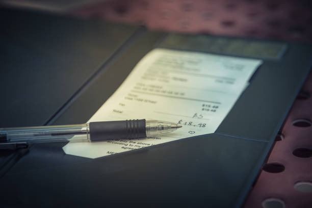 istock Open leather bill holder with restaurant check and pen 970199588