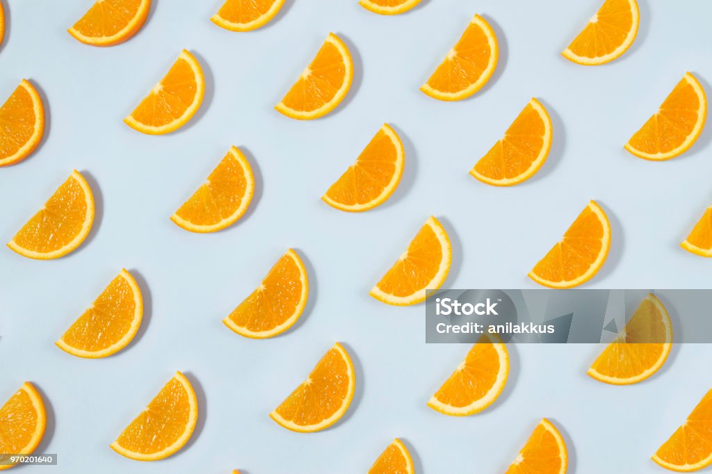 Orange Fruit Pattern on Blue Background Orange slices seamless background on blue background Orange - Fruit Stock Photo