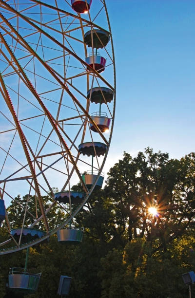 istock ferris wheel in front of blue sky and trees 970207552