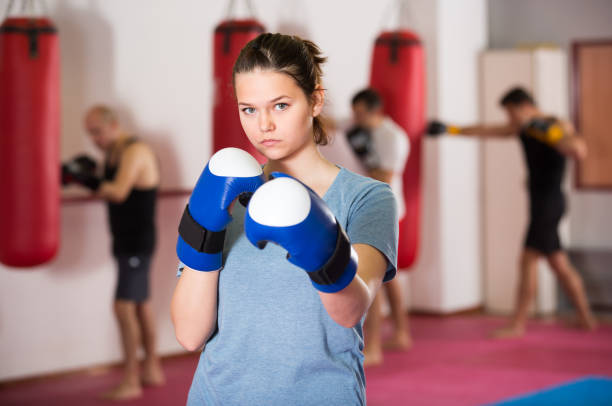 istock Young sportwoman practicing boxing punches 970215398
