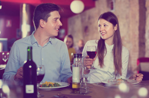 istock Loving pair enjoying evening meal and conversation at cozy restaurant 970218326