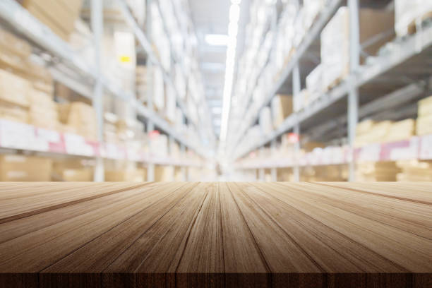 istock wood plank table top with warehouse store blur background 970224186