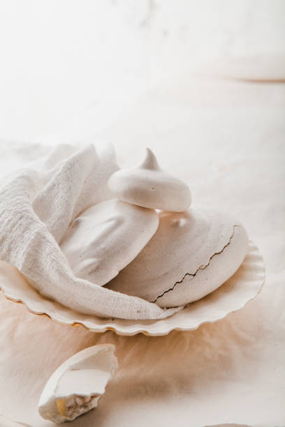 istock Homemade meringues on ceramic plate and linen fabric 970224536