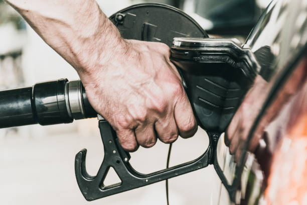 istock Close Up Man Hand Refueling Car 970224944