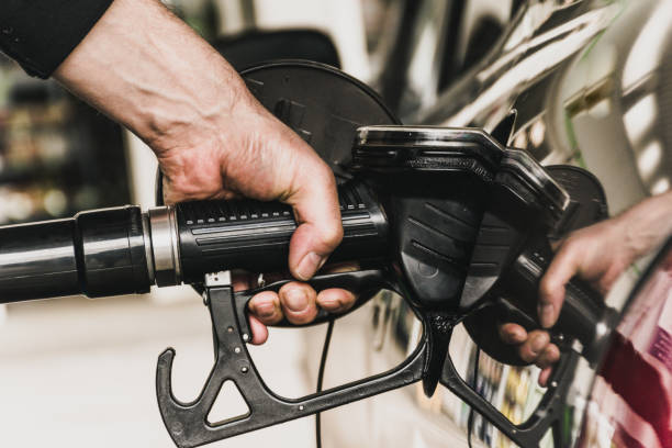 istock Close Up Man Hand Refueling Car 970224952