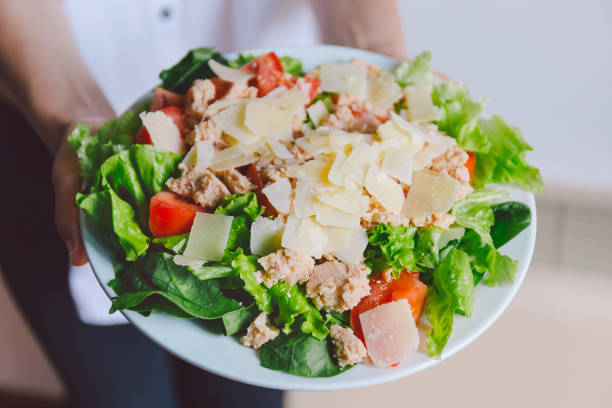 Girl holding healthy salad ready to eat Young girl hoding tasty fresh salad ready for dinner. Closeup horizontal kids eating tuna stock pictures, royalty-free photos & images