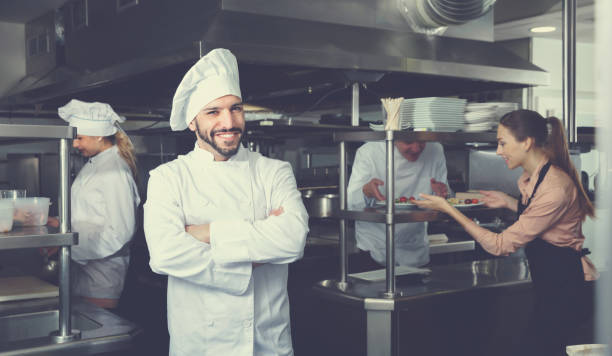 istock Portrait of satisfied smiling chef on restaurant kitchen 970225310