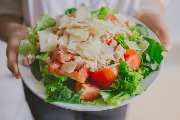 Girl holding healthy salad ready to eat Young girl hoding tasty fresh salad ready for dinner. Closeup horizontal kids eating tuna stock pictures, royalty-free photos & images