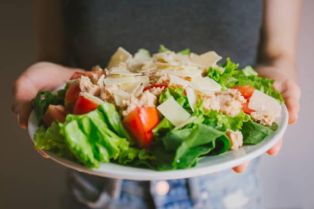 Girl holding healthy salad ready to eat Young girl hoding tasty fresh salad ready for dinner. Closeup horizontal kids eating tuna stock pictures, royalty-free photos & images