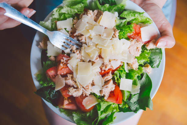 Girl holding healthy salad ready to eat Young girl hoding tasty fresh salad ready for dinner. Closeup horizontal kids eating tuna stock pictures, royalty-free photos & images