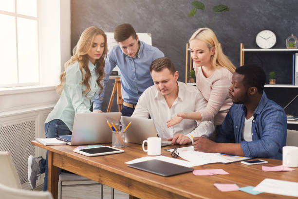istock Company coworkers discussing ideas in office 970227888