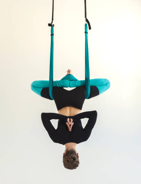 istock Woman practicing fly yoga over white background 970227966