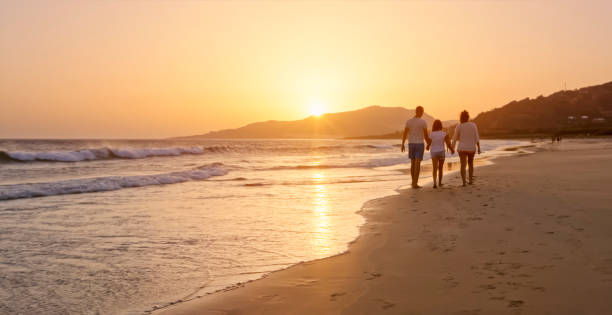istock Family walking on the beach 970228810