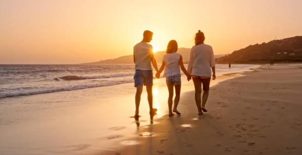 istock Family walking on the beach 970228816