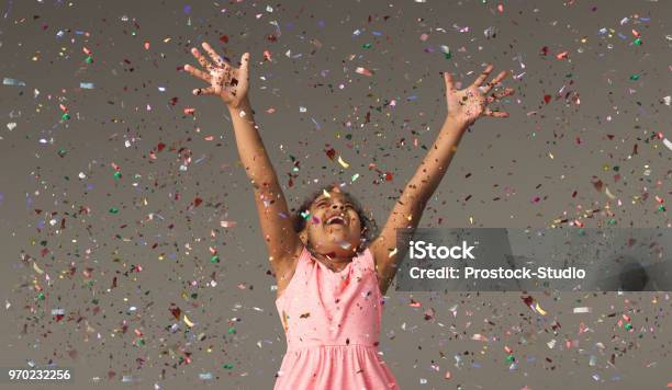 Happy Black Small Girl At White Studio Background Stock Photo - Download Image Now - Child, Celebration, Confetti