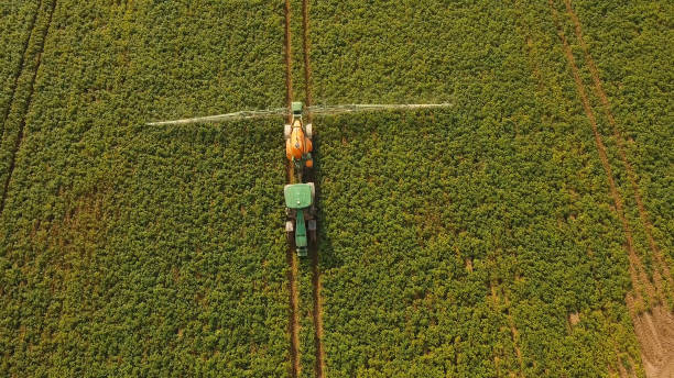 istock Tractor is spraying fertilizers field 970232258