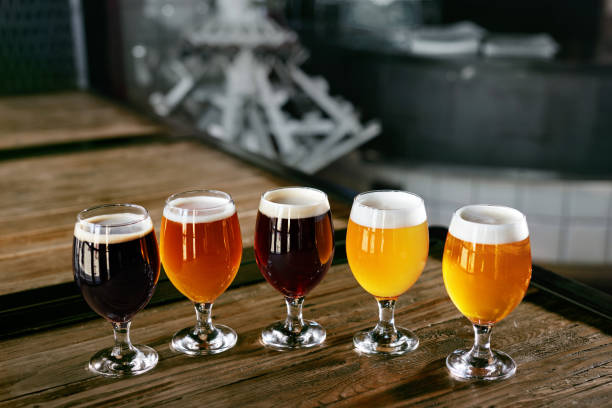 Beer Glasses On Wooden Table Closeup. Different Types Of Cold Fresh Beer In Bar Pub. High Resolution.