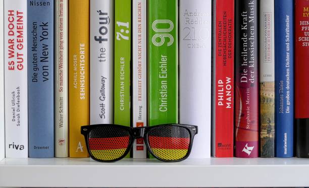 Sunglasses with german flag standing on books shelf