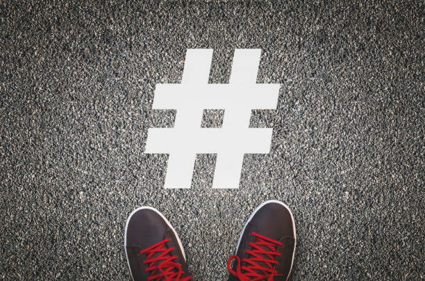 Hashtag Sneakers on asphalt road with white hashtag urban dictionary stock pictures, royalty-free photos & images