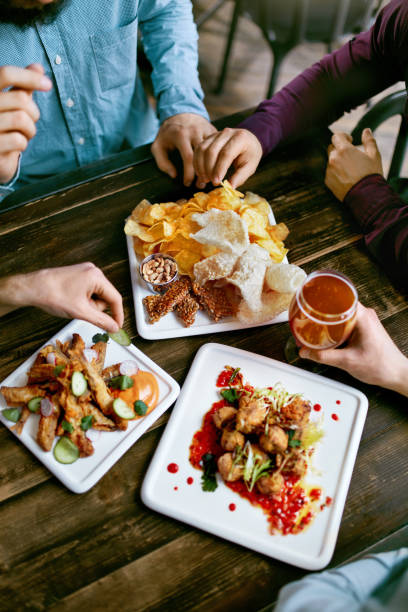 istock Men Drinking Beer And Eating Food Closeup 970236018
