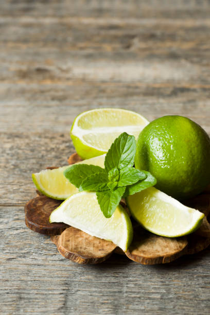 istock Fresh citrus lime mint berries on wooden background. Copy space for text 970236464