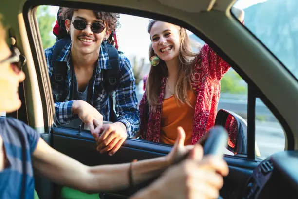 Young backpackers asking information to driver