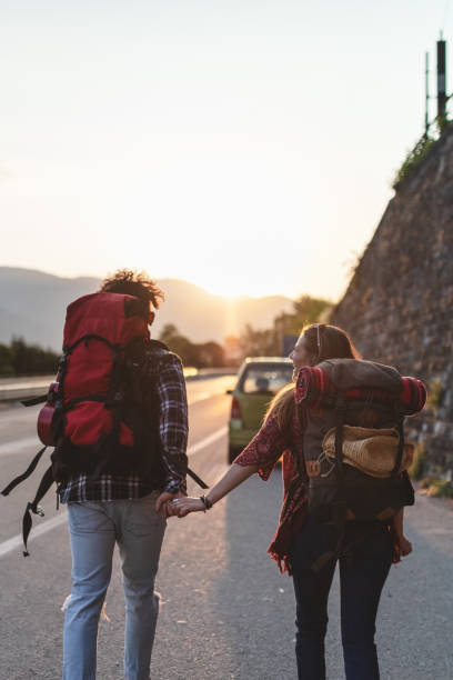 istock Backpackers hitchhiking on the road 970240498