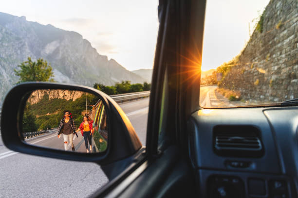 istock Backpackers hitchhiking on the road 970240548